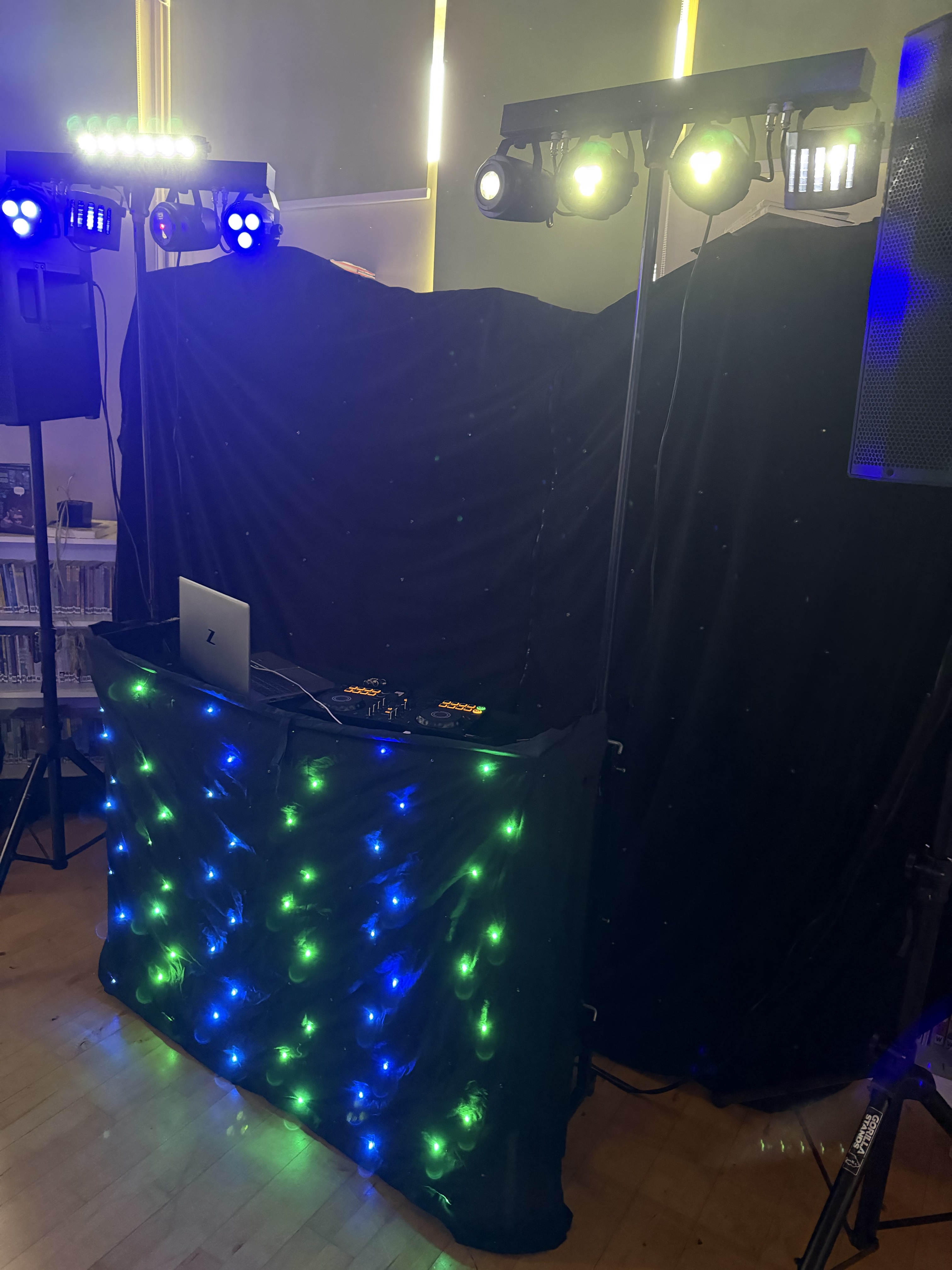 DJ booth with starcloth facade and lighting rig